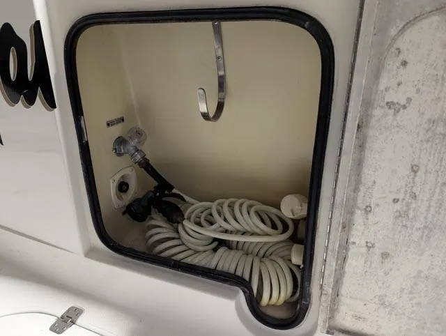 Her Endeavour II Yacht Photos Pics Storage compartment with coiled hose on a 1999 Carver 530 Voyager Pilothouse.