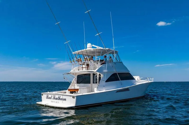 Reel Southern Yacht Photos Pics 2006 Viking 56 Convertible yacht on open water under clear blue sky.
