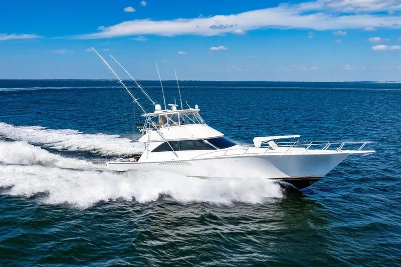 Reel Southern Yacht Photos Pics 2006 Viking 56 Convertible yacht cruising on open blue sea under clear sky.