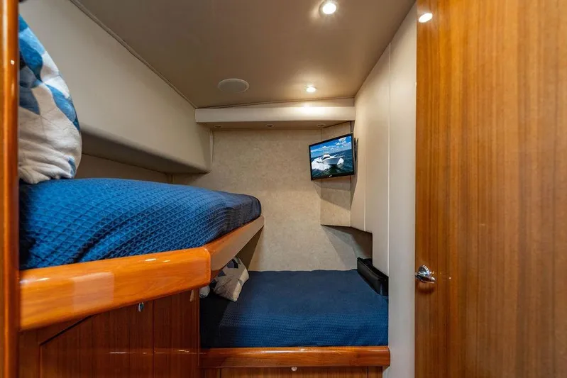 Reel Southern Yacht Photos Pics Interior of 2006 Viking 56 Convertible yacht with cozy bunk beds and TV.