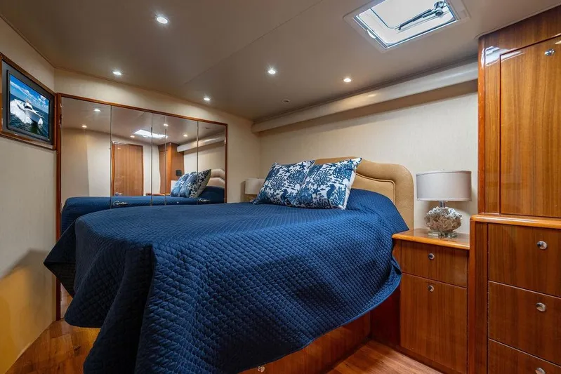 Reel Southern Yacht Photos Pics Luxurious cabin interior of 2006 Viking 56 Convertible yacht with elegant bedding and wood finishes.