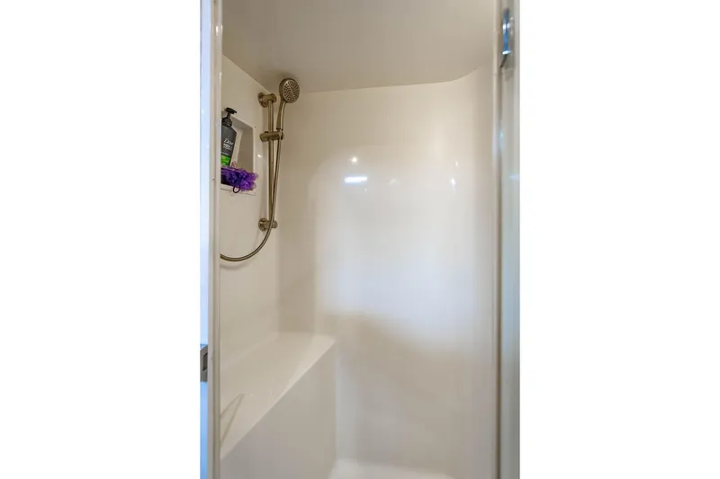 Reel Southern Yacht Photos Pics Shower area in 2006 Viking 56 Convertible yacht, featuring a handheld showerhead.