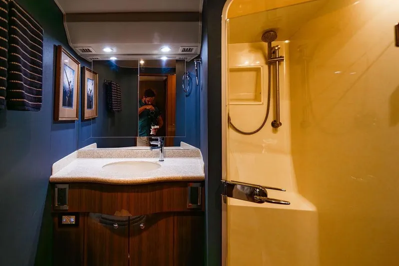 Reel Southern Yacht Photos Pics Luxurious bathroom in 2006 Viking 56 Convertible yacht with modern fixtures and elegant decor.