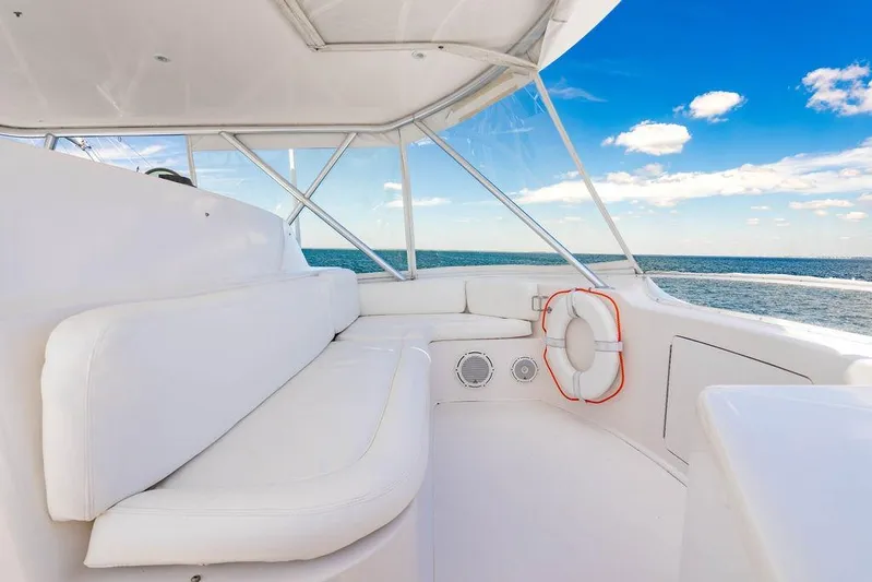 Reel Southern Yacht Photos Pics 2006 Viking 56 Convertible yacht interior with white seating, ocean view, and blue sky.