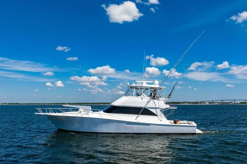 Reel Southern Yacht Photos Pics 2006 Viking 56 Convertible yacht cruising on a sunny day with blue skies.