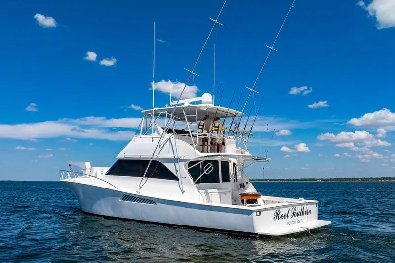 Reel Southern Yacht Photos Pics 2006 Viking 56 Convertible yacht on open water under clear blue sky.