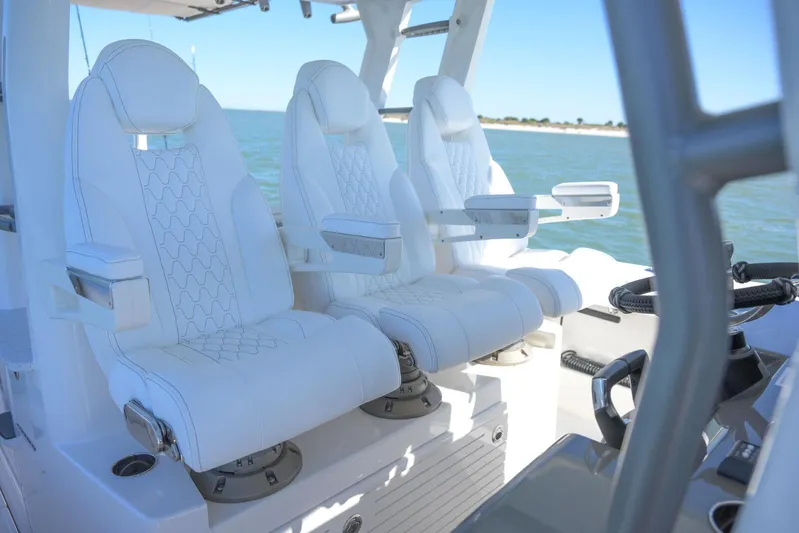  Yacht Photos Pics Luxurious white seating on 2025 Solace 37 CS boat, featuring ergonomic design and ocean backdrop.