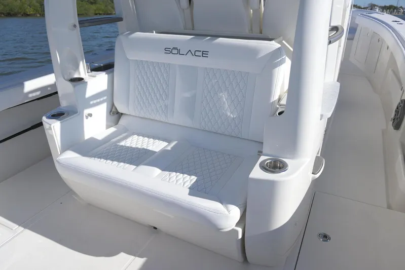 Yacht Photos Pics Luxury seating on 2025 Solace 37 CS boat, featuring elegant white upholstery and cup holders.