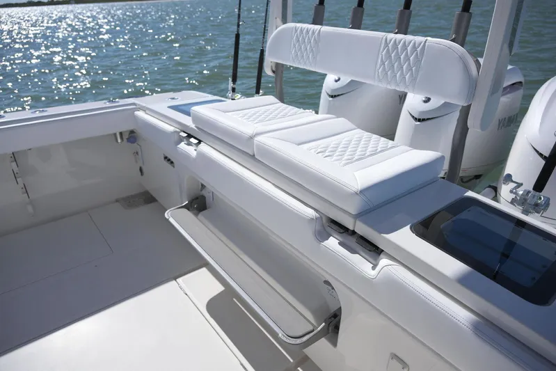  Yacht Photos Pics 2025 Solace 37 CS boat interior with white cushioned seating and ocean backdrop.