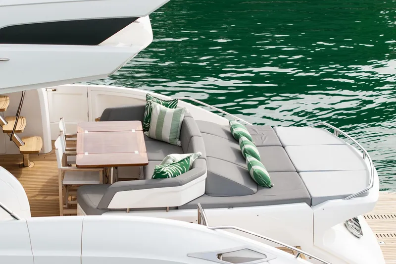 Cinderella Yacht Photos Pics Luxurious 2017 Princess S65 yacht deck with seating and dining area by the water.