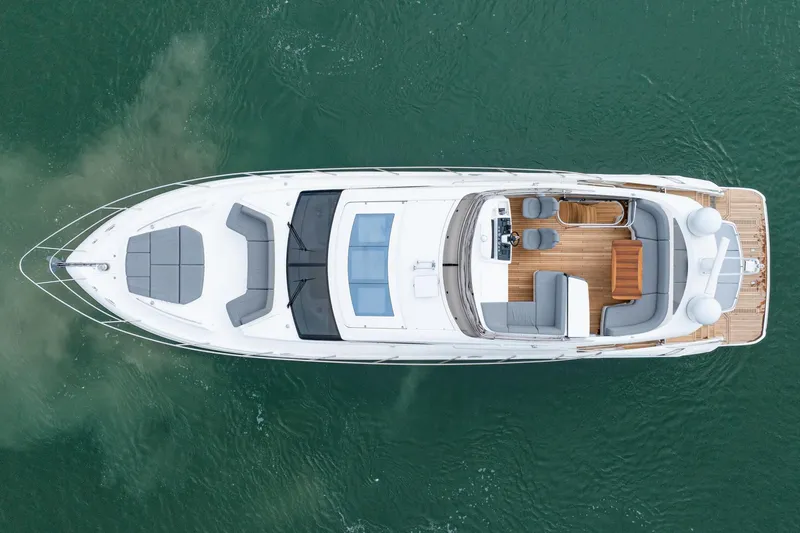 Cinderella Yacht Photos Pics Aerial view of 2017 Princess S65 yacht on water, showcasing sleek design and spacious deck.