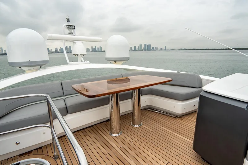 Cinderella Yacht Photos Pics Luxurious 2017 Princess S65 yacht deck with seating and table, overlooking city skyline.