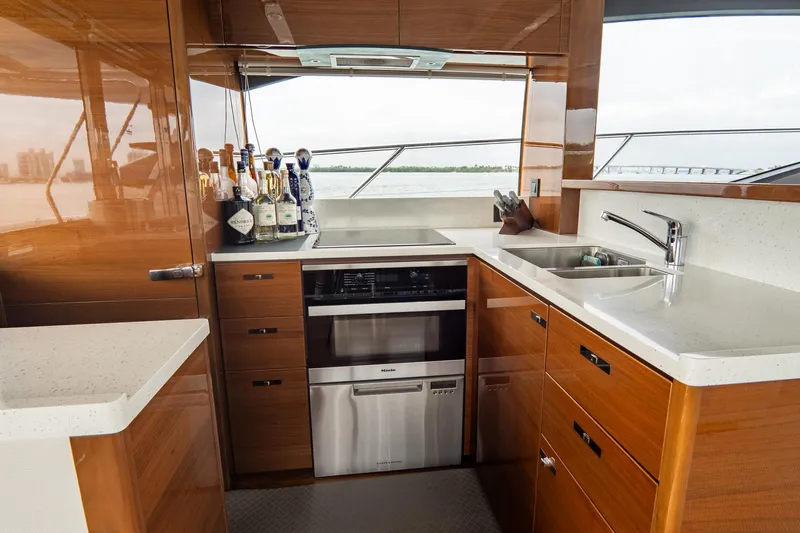 Cinderella Yacht Photos Pics Luxurious kitchen interior of 2017 Princess S65 yacht with modern appliances and sleek design.