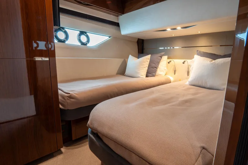 Cinderella Yacht Photos Pics Luxurious cabin interior of 2017 Princess S65 yacht with twin beds and elegant decor.