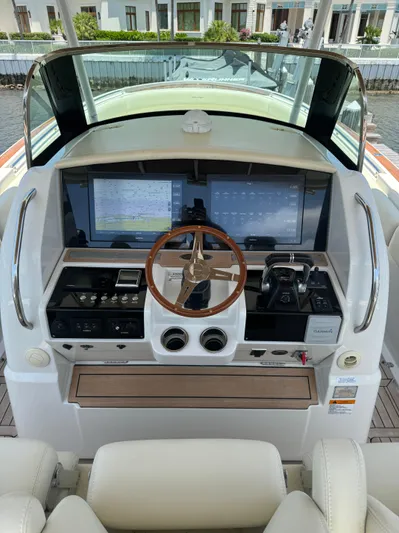 Yacht Photos Pics Helm of 2016 Chris-Craft Catalina 34 with modern navigation systems and wooden steering wheel.