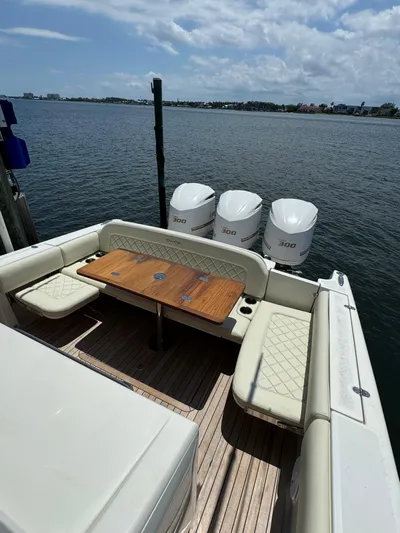  Yacht Photos Pics 2016 Chris-Craft Catalina 34 boat with triple outboard engines docked by the water.