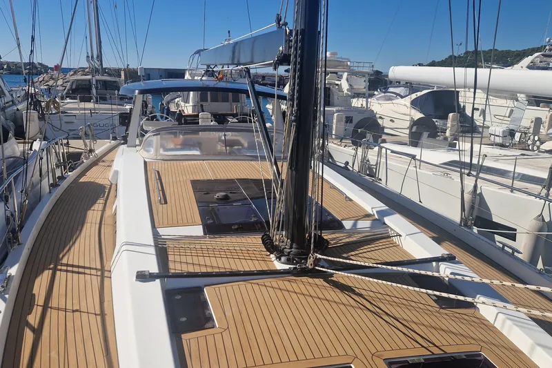  Yacht Photos Pics 2019 Hanse 588 yacht with sleek deck design, docked in a marina.