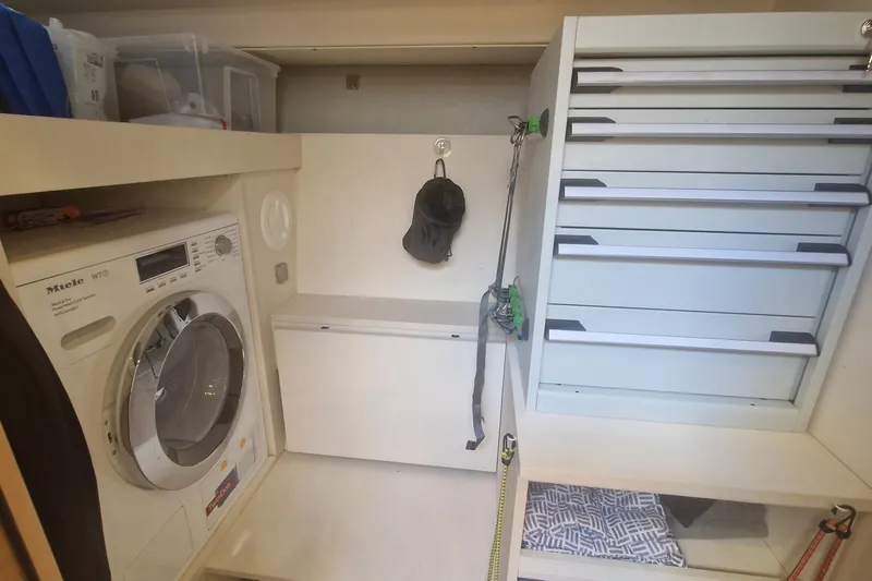  Yacht Photos Pics Laundry area in 2019 Hanse 588 yacht with Miele washer and storage drawers.