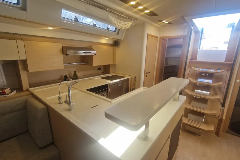  Yacht Photos Pics Luxurious interior of 2019 Hanse 588 yacht featuring modern kitchen and elegant design.