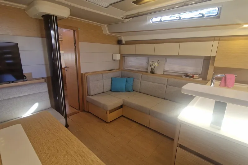  Yacht Photos Pics Modern interior of 2019 Hanse 588 yacht with cozy seating and elegant decor.