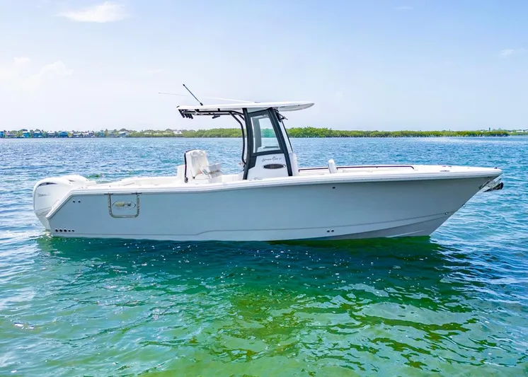  Yacht Photos Pics 2026 Sea Hunt Gamefish 27 boat on clear blue water, side view.