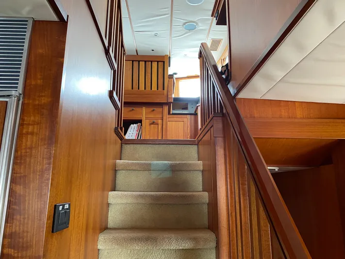 Meander Yacht Photos Pics Interior of 2003 Northern Marine Pilothouse Trawler with wooden staircase.