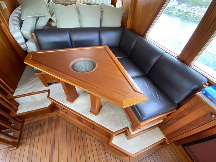 Meander Yacht Photos Pics Interior of 2003 Northern Marine Pilothouse Trawler with leather sofa and wooden table.