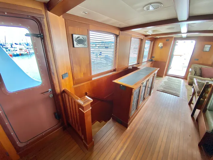 Meander Yacht Photos Pics Interior of 2003 Northern Marine Pilothouse Trawler with wooden floors and staircase.