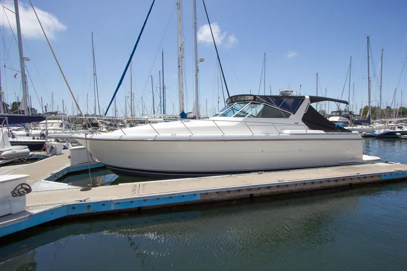 Sparrow Yacht Photos Pics 1995 Tiara Yachts 4000 Express docked in a marina under a clear blue sky.