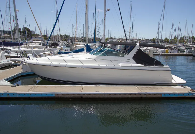 Sparrow Yacht Photos Pics 1995 Tiara Yachts 4000 Express docked in a marina, surrounded by sailboats.