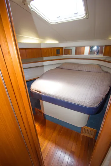Sparrow Yacht Photos Pics 1995 Tiara Yachts 4000 Express cabin with bed, wooden interior, and overhead hatch.