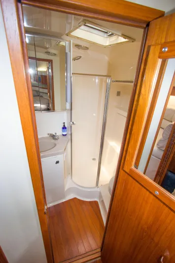 Sparrow Yacht Photos Pics Bathroom interior of 1995 Tiara Yachts 4000 Express with shower and wooden accents.