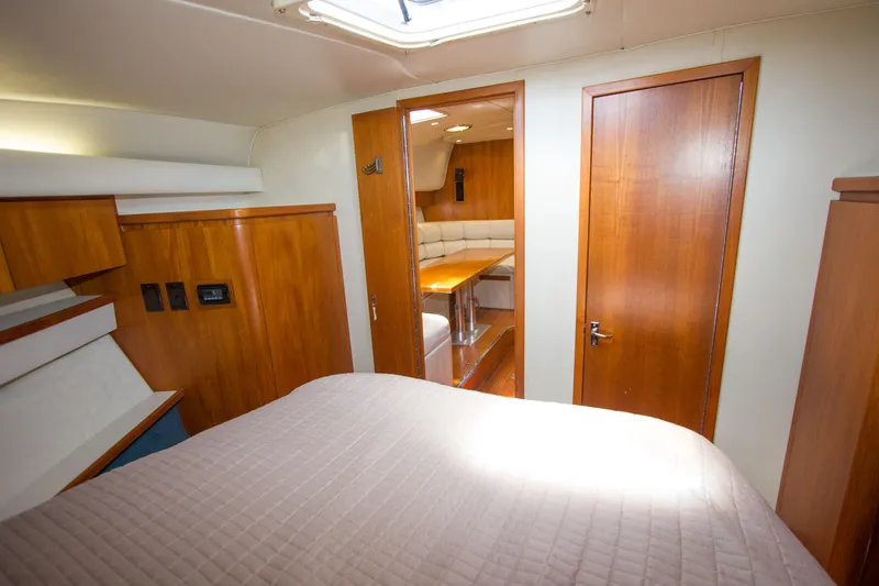 Sparrow Yacht Photos Pics 1995 Tiara Yachts 4000 Express cabin interior with wood finish and cozy seating area.