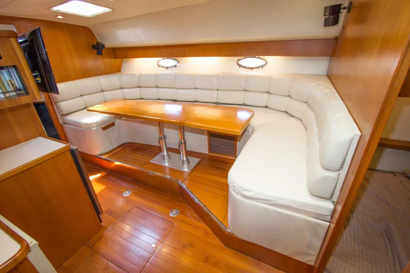 Sparrow Yacht Photos Pics 1995 Tiara Yachts 4000 Express interior with plush seating and wooden table.