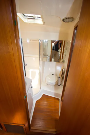 Sparrow Yacht Photos Pics 1995 Tiara Yachts 4000 Express bathroom with wooden flooring and compact design.