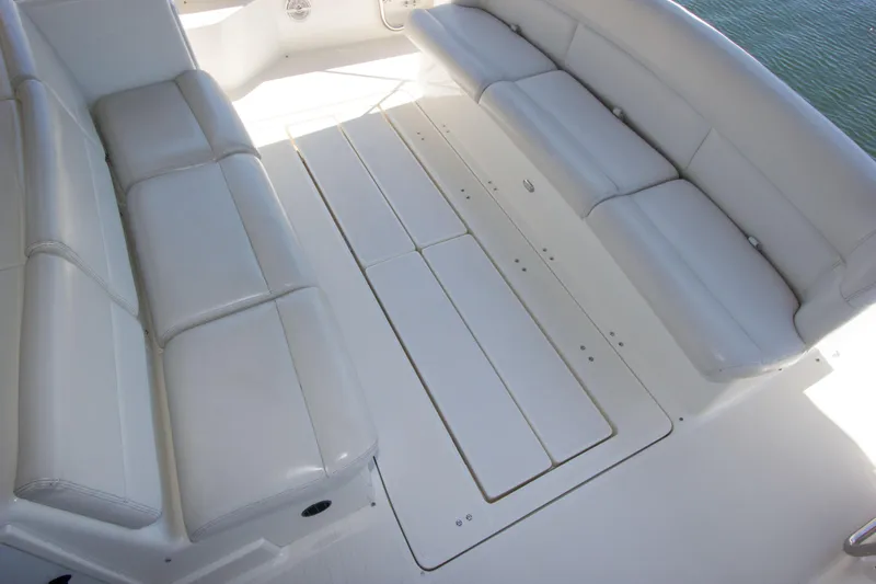 Sparrow Yacht Photos Pics Spacious seating area on 1995 Tiara Yachts 4000 Express, featuring white cushioned benches.