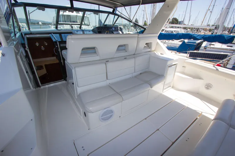 Sparrow Yacht Photos Pics 1995 Tiara Yachts 4000 Express interior with white seating and helm, docked at marina.