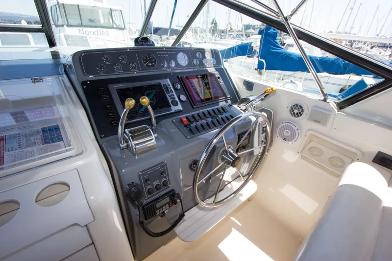 Sparrow Yacht Photos Pics 1995 Tiara Yachts 4000 Express helm with steering wheel and navigation controls.