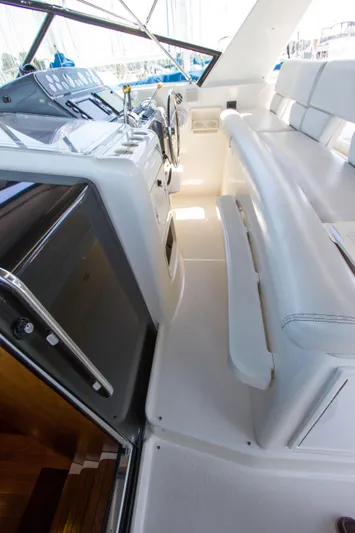 Sparrow Yacht Photos Pics 1995 Tiara Yachts 4000 Express cockpit with white seating and helm controls.