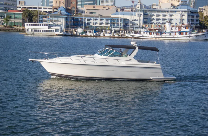 Sparrow Yacht Photos Pics 1995 Tiara Yachts 4000 Express cruising in a harbor with cityscape background.
