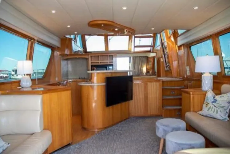 Prudence Yacht Photos Pics Luxurious interior of 2005 McKinna 57 Pilothouse yacht with modern furnishings and large windows.