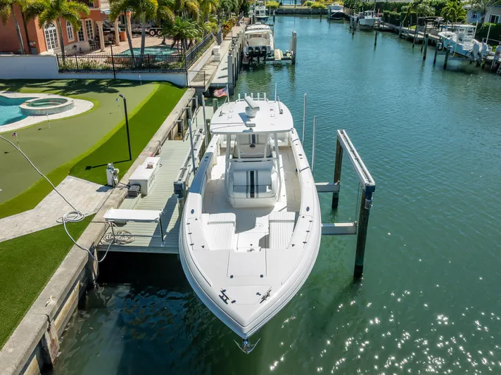  Yacht Photos Pics 2010 Intrepid 370 Open boat docked in a sunny canal setting.