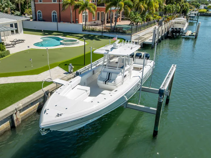 Yacht Photos Pics 2010 Intrepid 370 Open boat docked near luxury waterfront property.