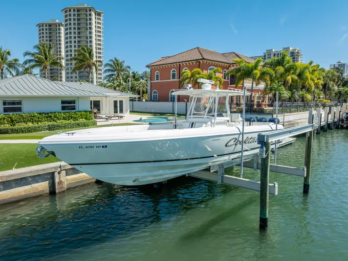  Yacht Photos Pics Intrepid 370 Open 2010 boat docked in a scenic waterfront setting with palm trees.
