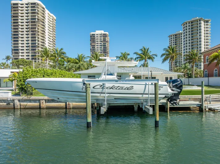  Yacht Photos Pics Intrepid 370 Open 2010 boat docked near waterfront buildings and palm trees.