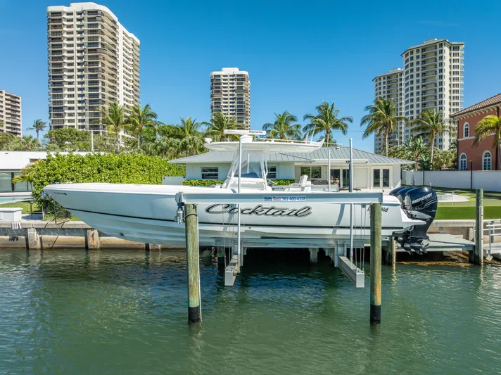  Yacht Photos Pics Intrepid 370 Open 2010 boat docked, surrounded by palm trees and high-rise buildings.