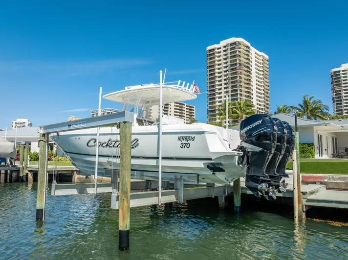  Yacht Photos Pics 2010 Intrepid 370 Open boat docked with twin Mercury engines, against a cityscape backdrop.