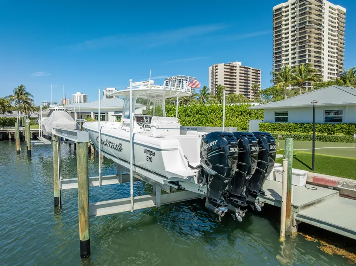  Yacht Photos Pics 2010 Intrepid 370 Open boat docked with triple Mercury engines, coastal background.
