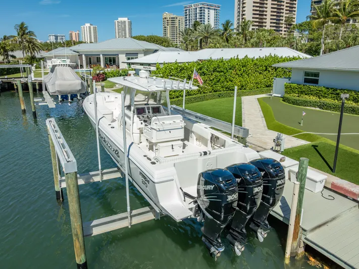 Yacht Photos Pics 2010 Intrepid 370 Open boat with triple Mercury engines docked in a marina.