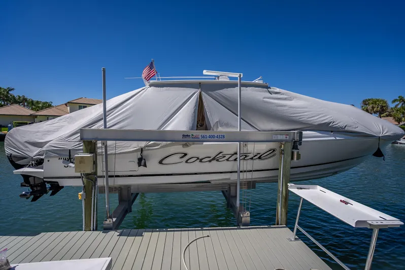 Yacht Photos Pics 2010 Intrepid 370 Open boat covered and docked, with American flag, on a sunny day.